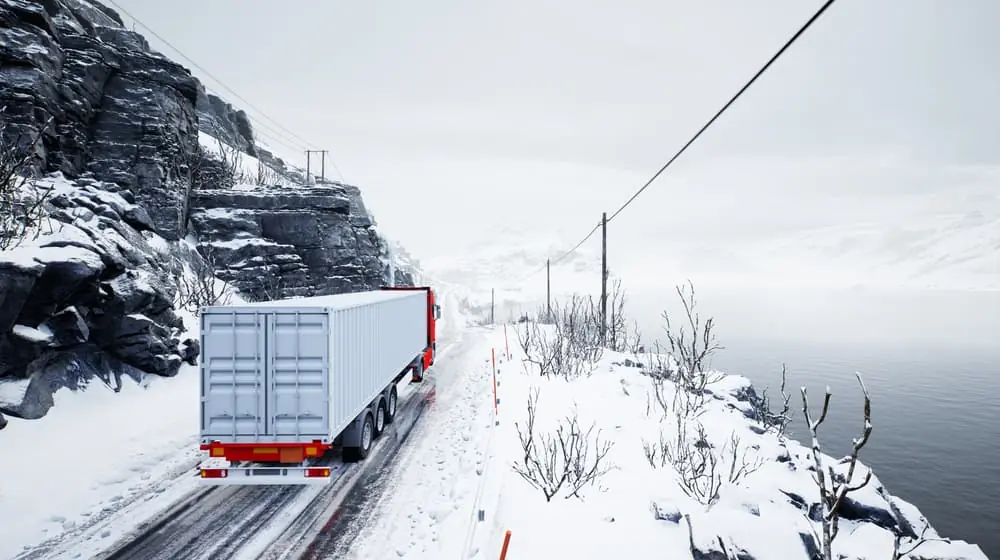 truck hauling a heated container down a snowy road