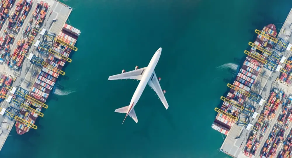 aerial top down view of airplane over container yard