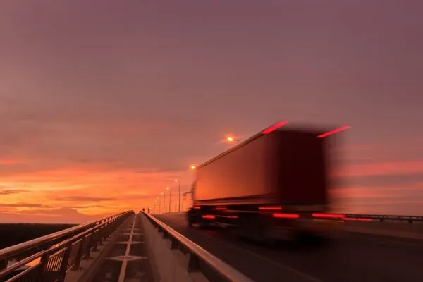 Beautiful sunset with Blurred truck on the road