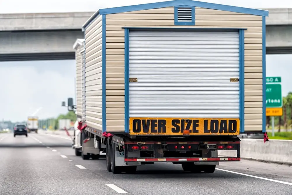 Oversize over size load hauler truck trailer vehicle hauling mobile module home house on North Carolina interstate highway road