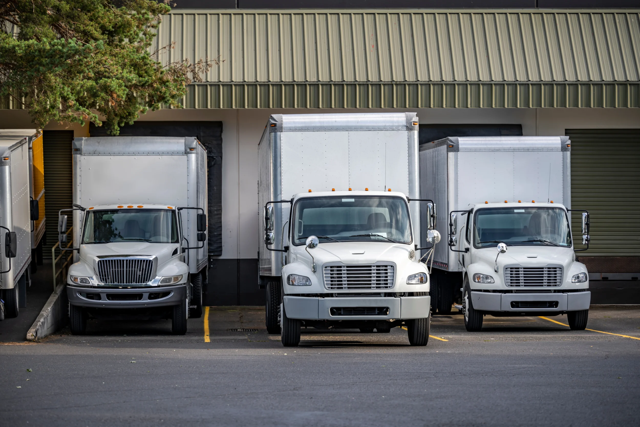 Short-haul-line-of-smaller-trucks-at-loading-dock