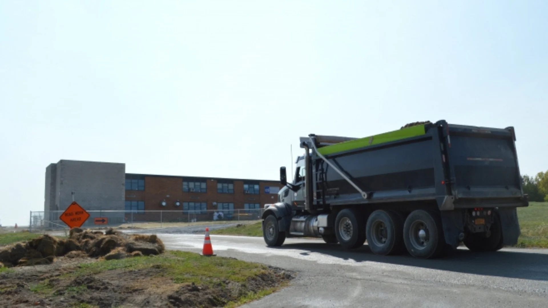 dump truck heading towards a plant