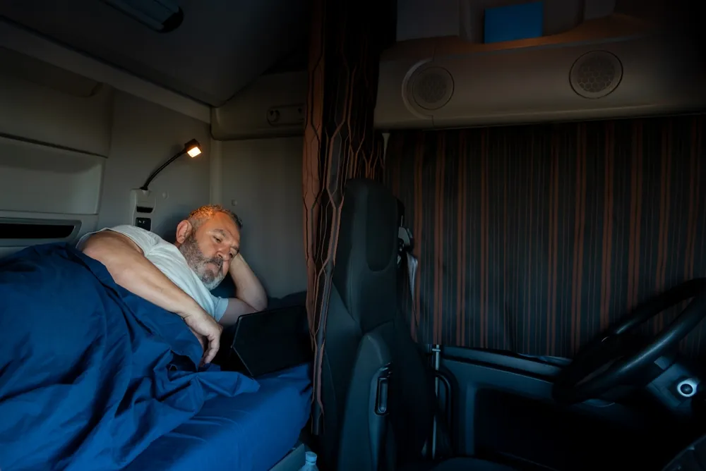 long haul driver lying in sleeper cab