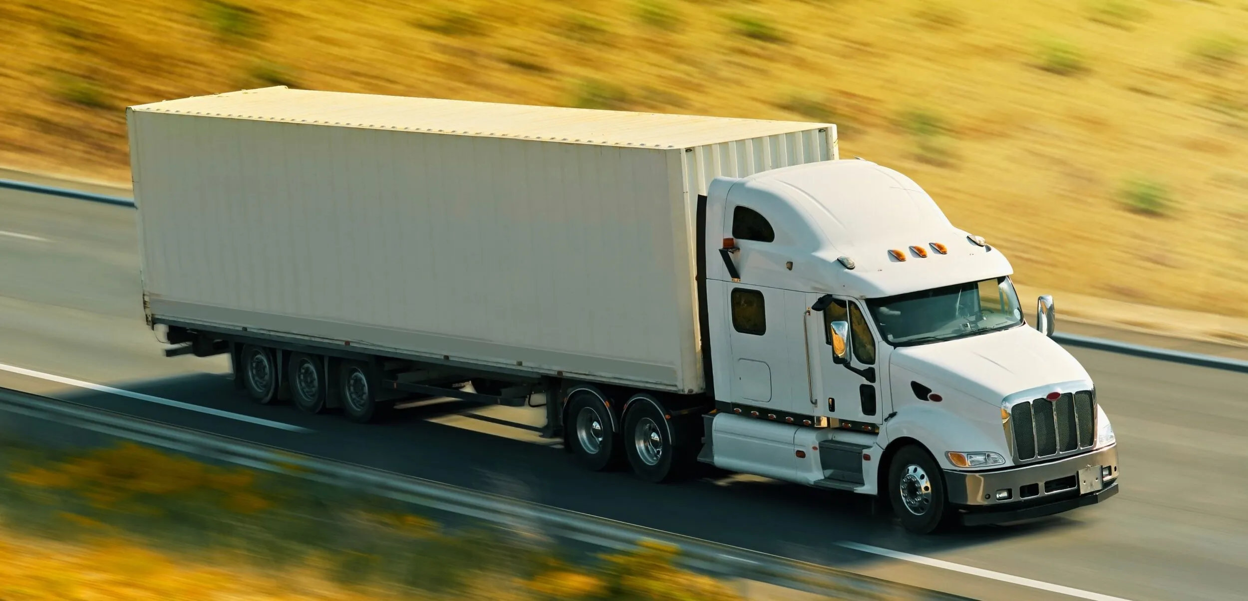 long-haul-semi-truck-driving-down-highway