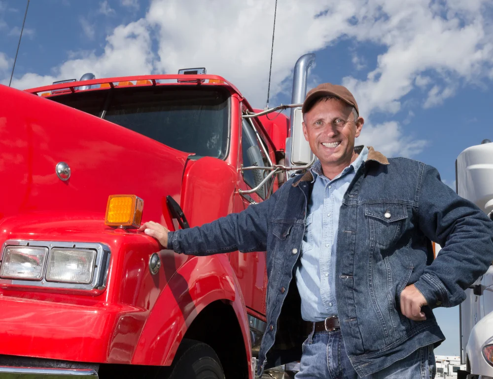 short-haul-vs.-long-haul-trucker smiling-in-front-of-truck