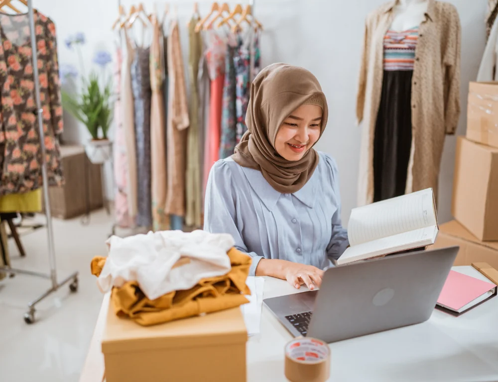 Ecommerce-Shipping-woman-working-in-clothing-business-working-on-laptop