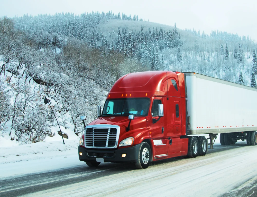 Freight-Hauler-red-semi-truck-driving-down-snowy-highway