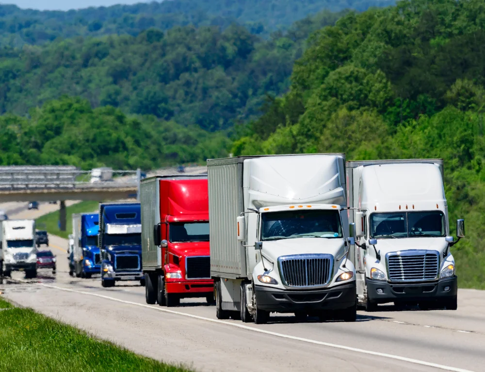 Interstate truckers-line-of-semi-trucks-driving-down-highway