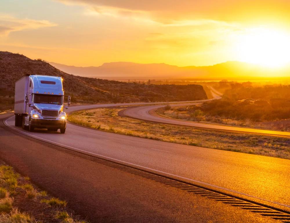 Interstate Drivers-truck-driving-down-desert-highway-during-sunset