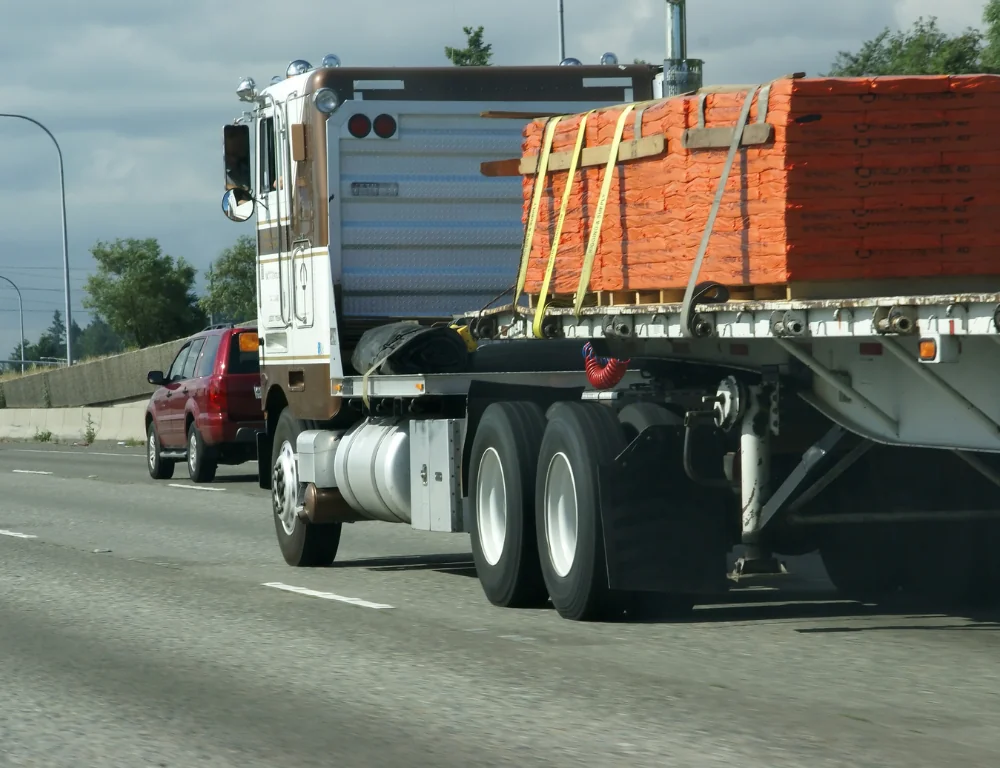 freight-marketplace-flatbed-truck-driving-down-road