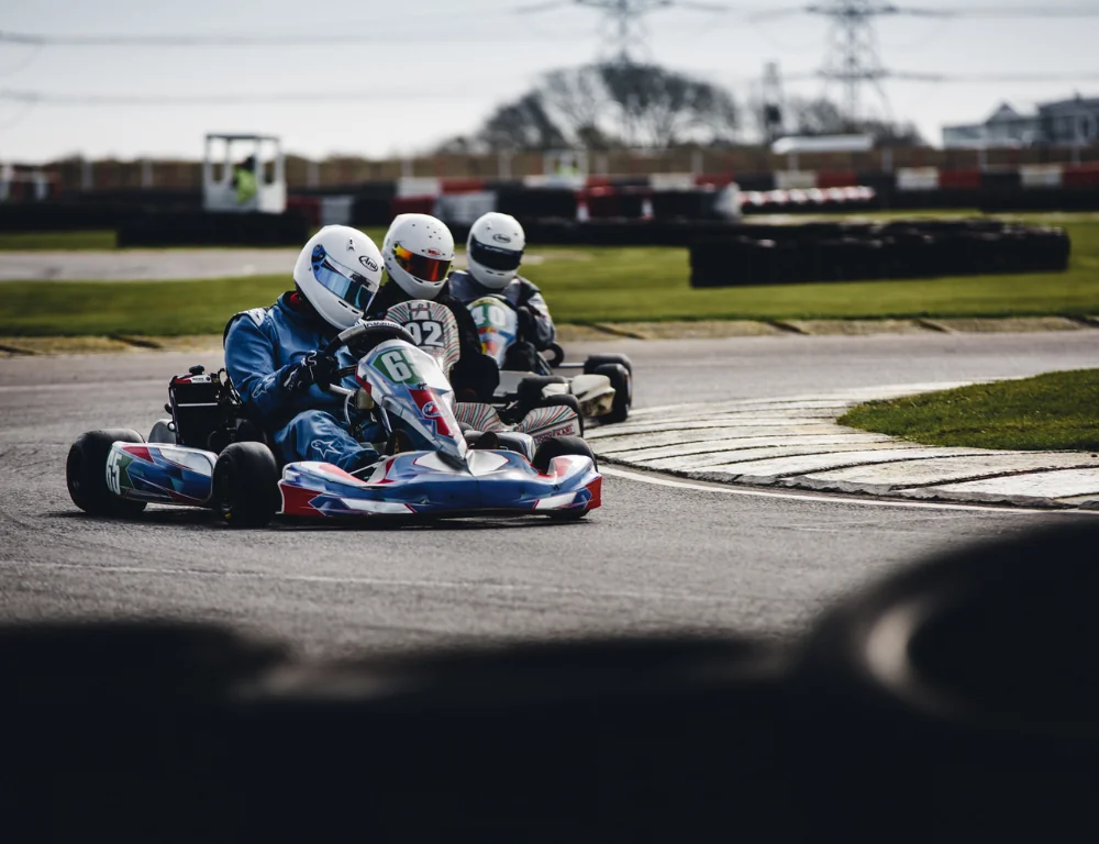 three men riding on go-karts