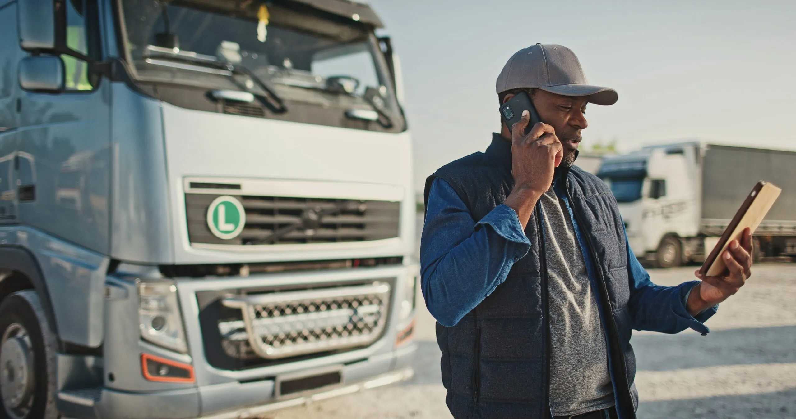 load-board-driver-looking-at-tablet-in-front-of-truck