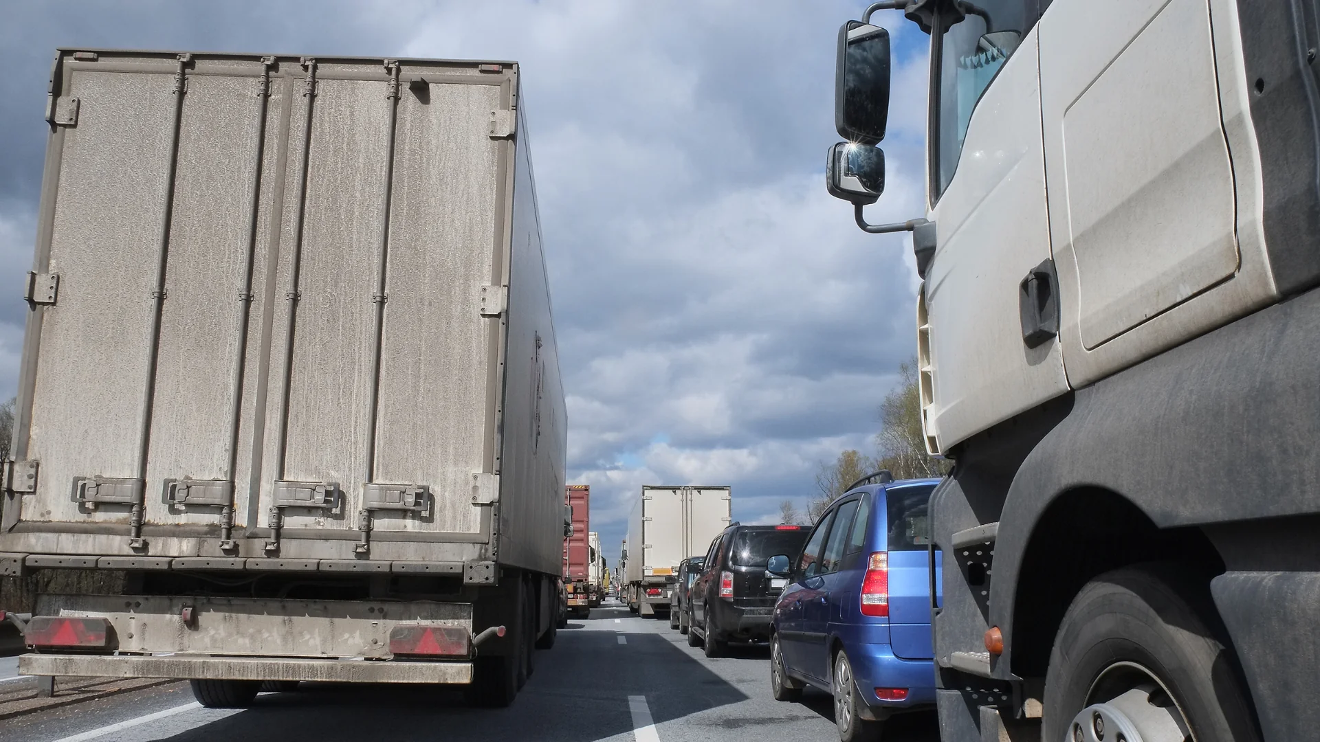 Freight Shipping Costs Surge trucks and cars stuck in traffic jam