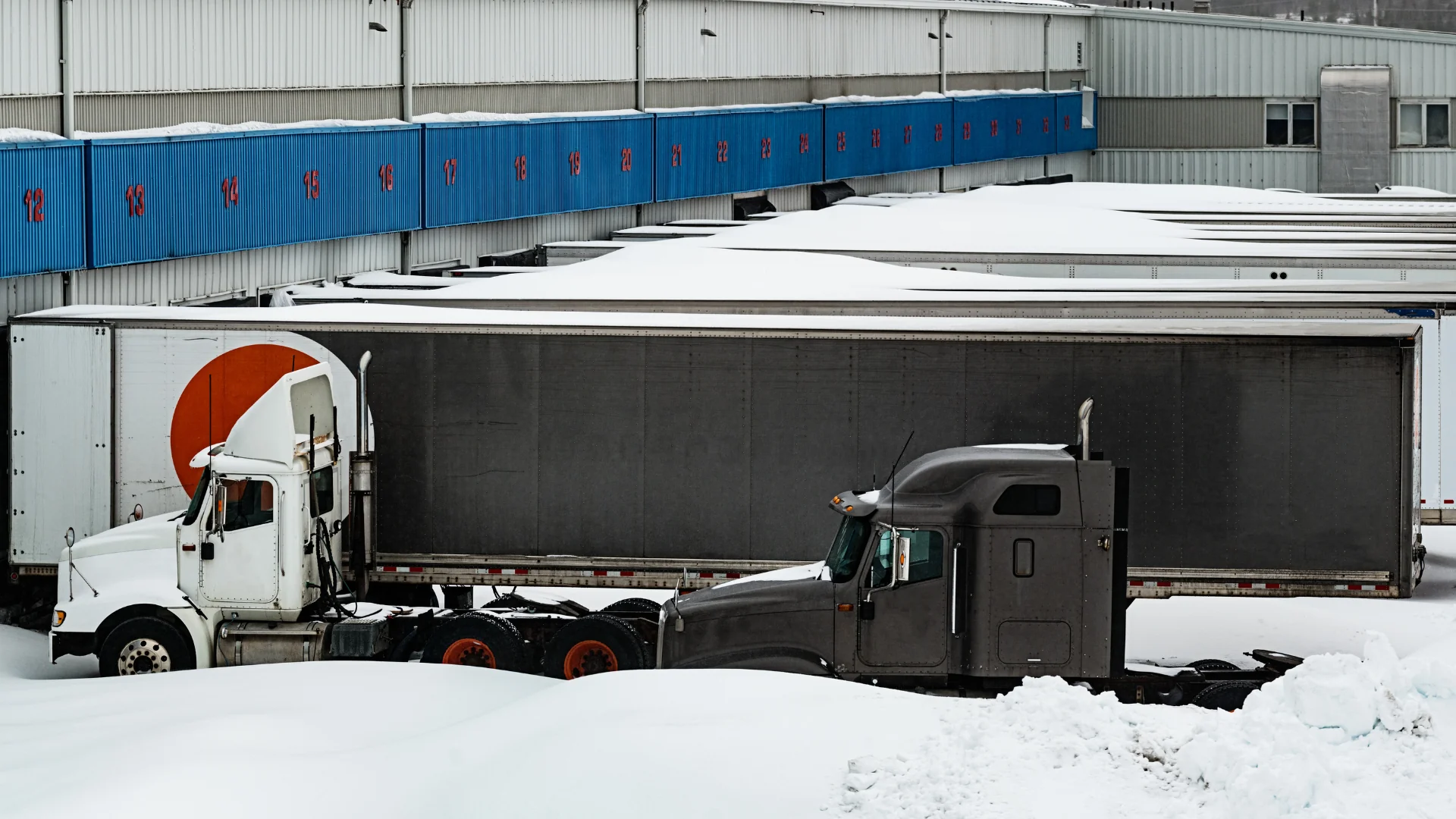 Freight Shipping Costs Surge trucks stuck at snowed in terminal