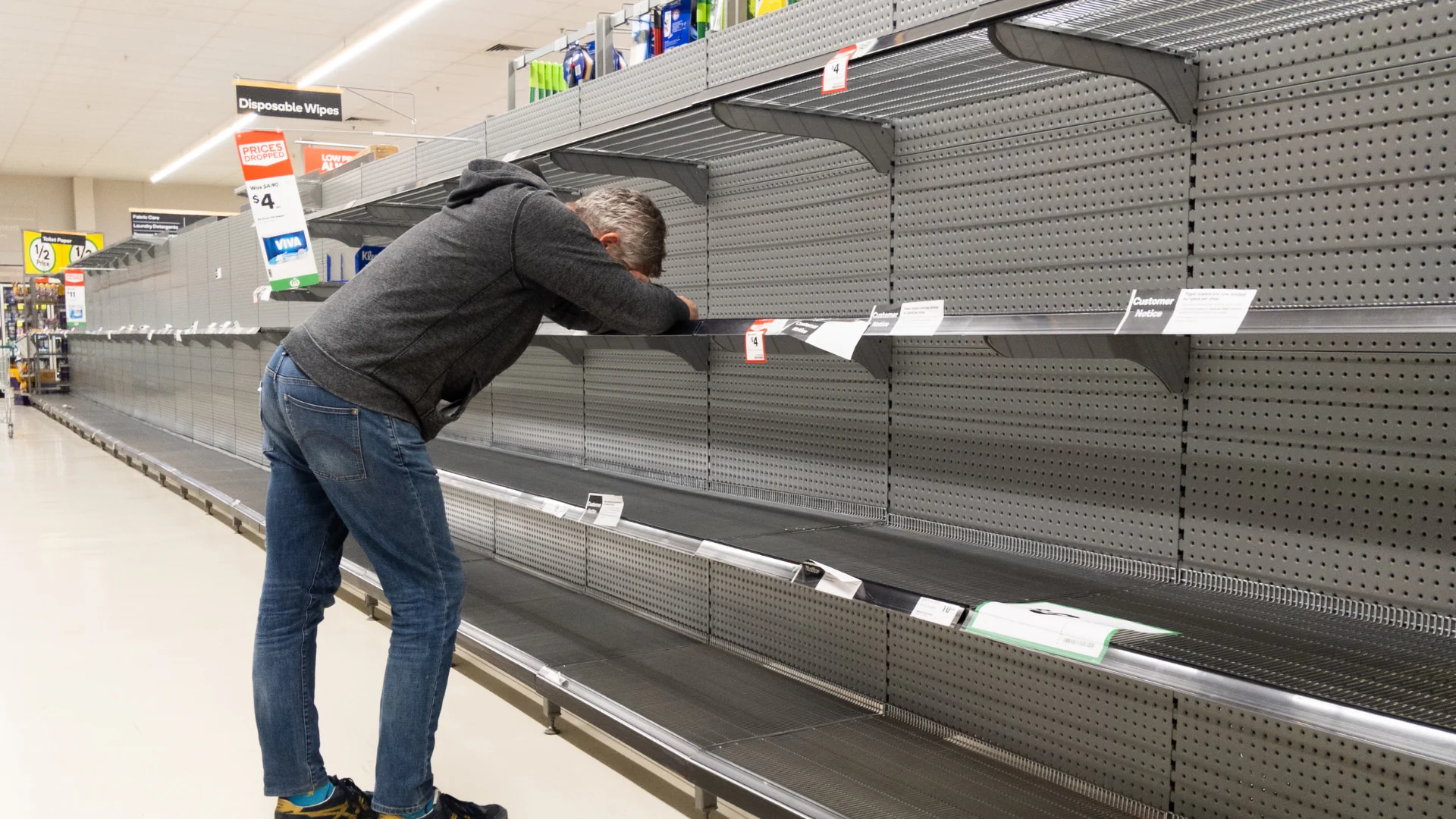 Freight Shipping Costs Surge upset man leans on empty store shelves