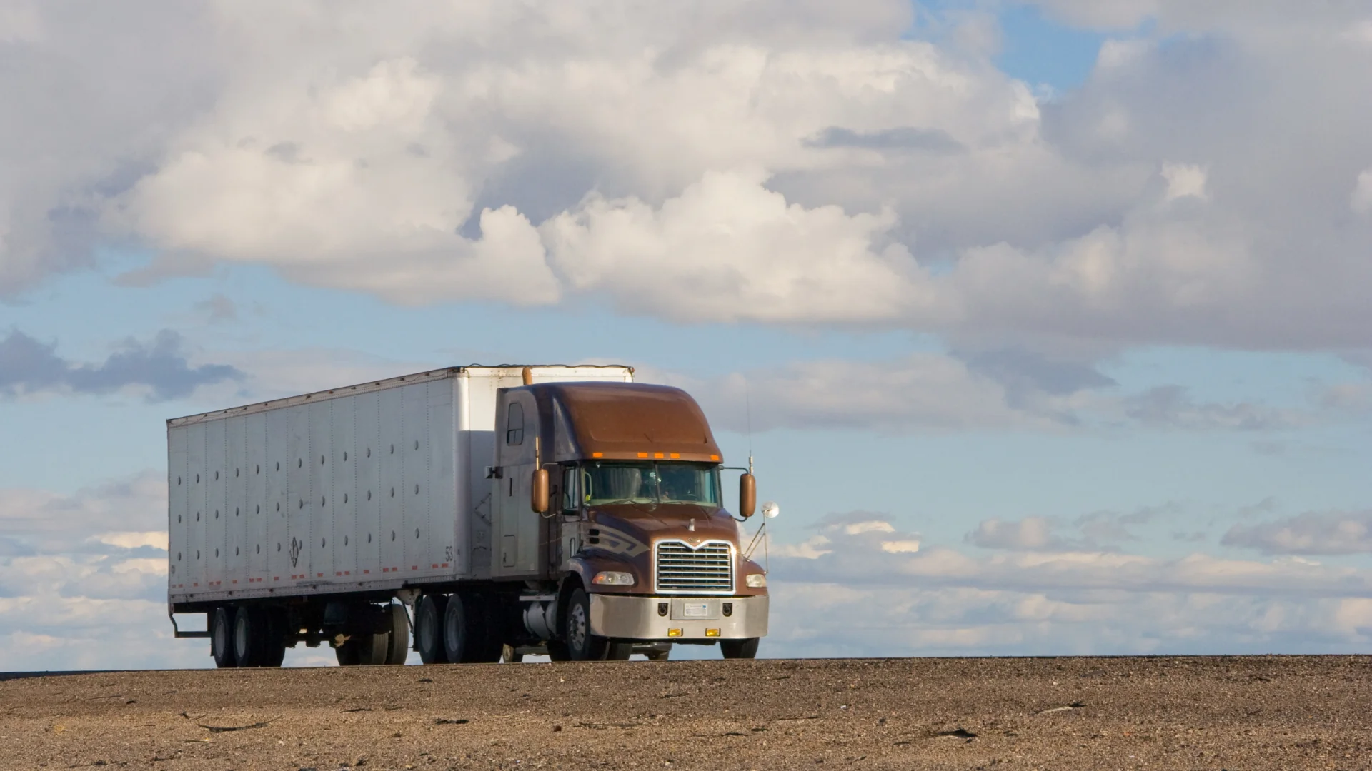 LTL Freight Transit Time Estimates- semi trailer truck driving in the desert Bison Transport claims