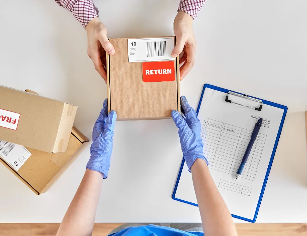 Using Reverse Shipping Logistics-person-returning-package-to-store-clerk