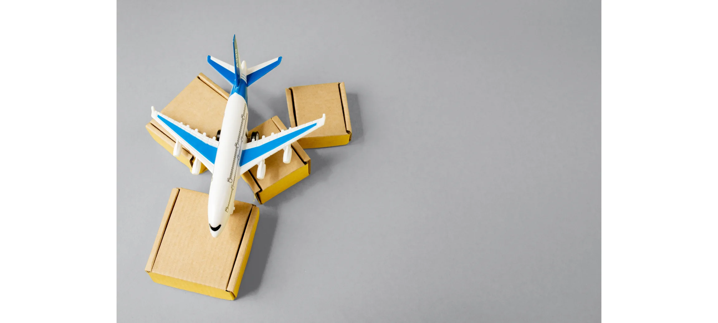 top down view of a miniature airplane on top of cardboard boxes