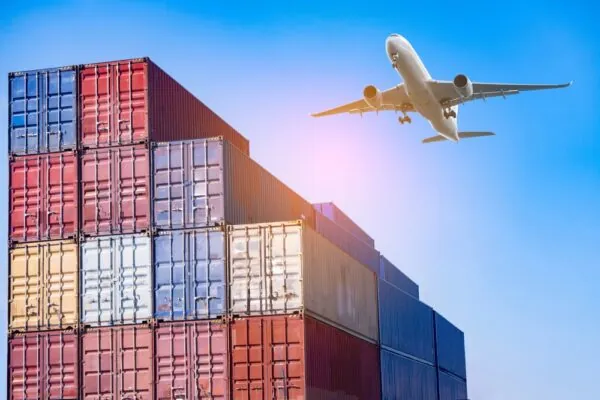 airplane flying above containers