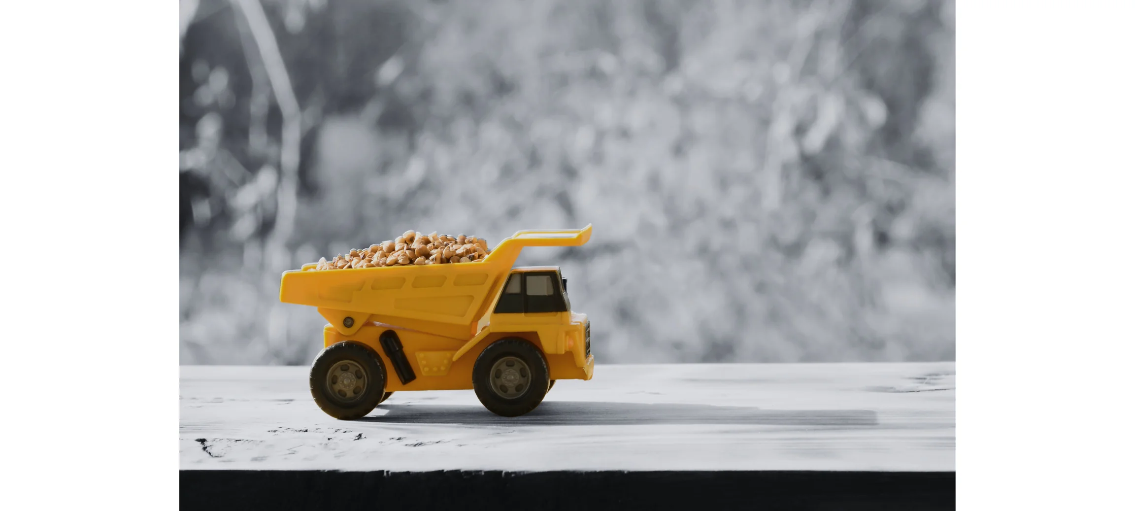 yellow toy dump truck carrying rocks