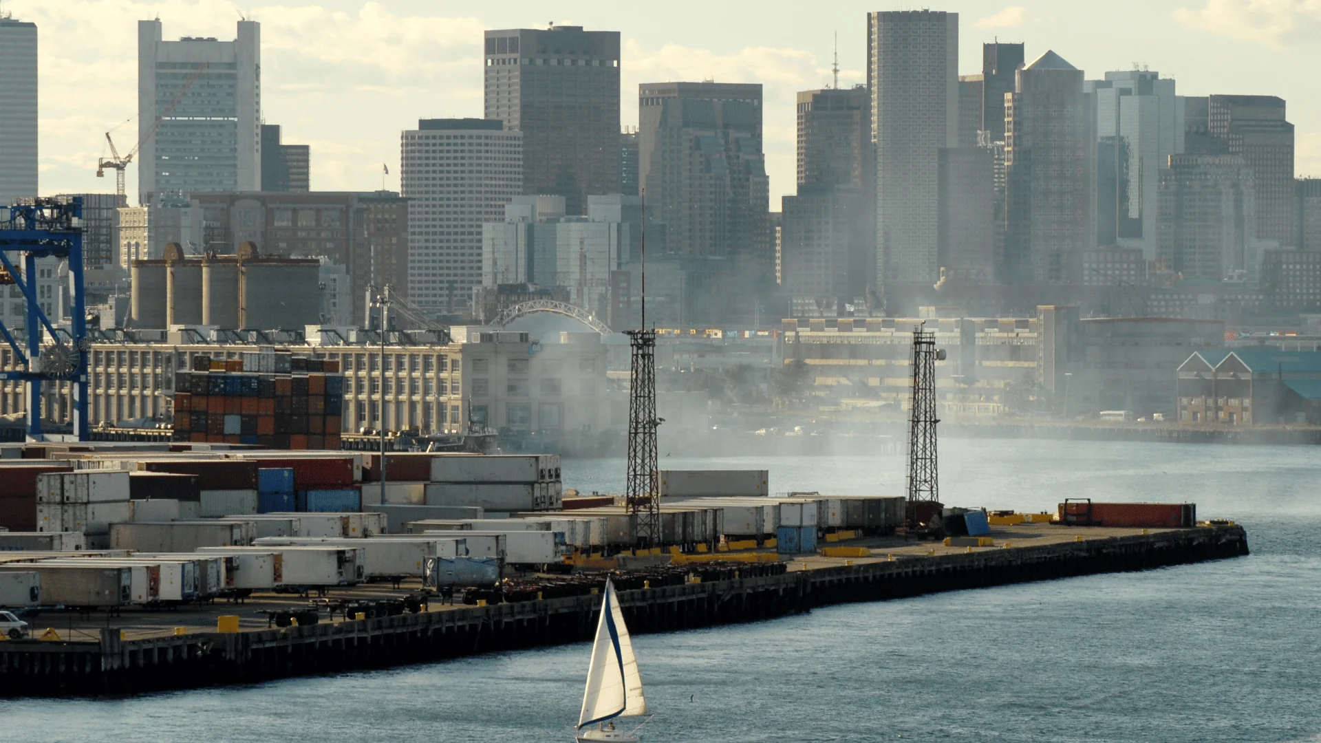 Boston Freight Shipping container port on the water by Boston buildings