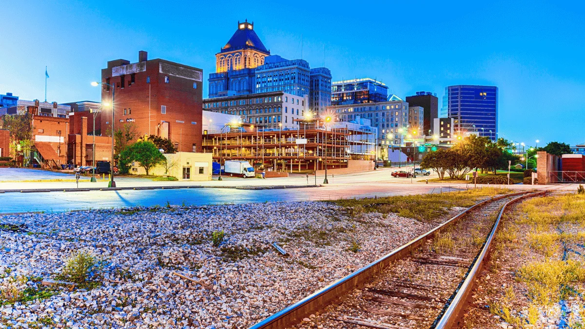 Greensboro Freight Shipping ground view of buildings and railroad track in Greensboro at night