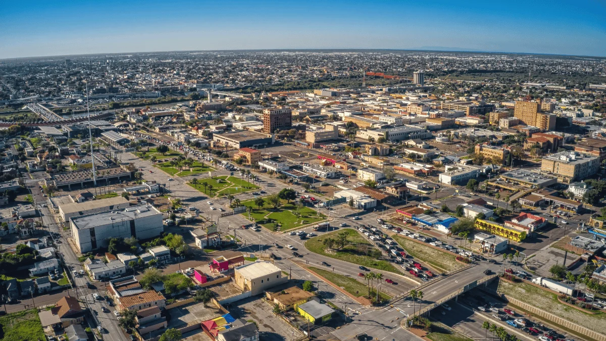 Laredo Freight Shipping aerial view of traffic in Laredo leading to border crossing with rail bridge in the distance