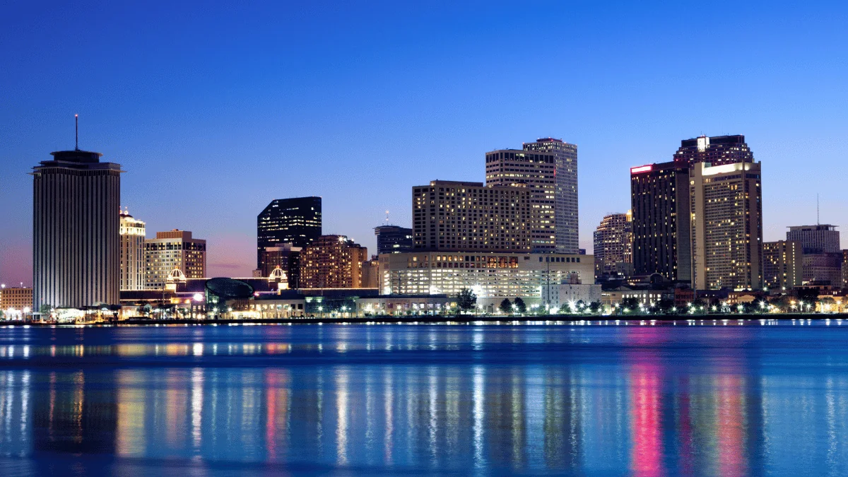 New Orleans freight shipping New Orleans cityscape skyline at night over Mississippi River