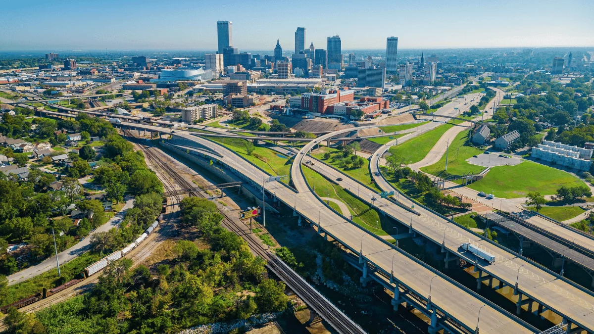 Tulsa Freight Shipping aerial view of Tulsa cityscape with highways and railroads in foreground