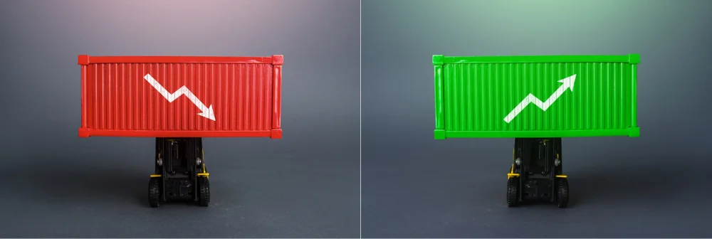 red shipping container with a down arrow and a green shipping container with a up arrow 