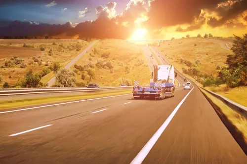 lowboy trailer on the open road