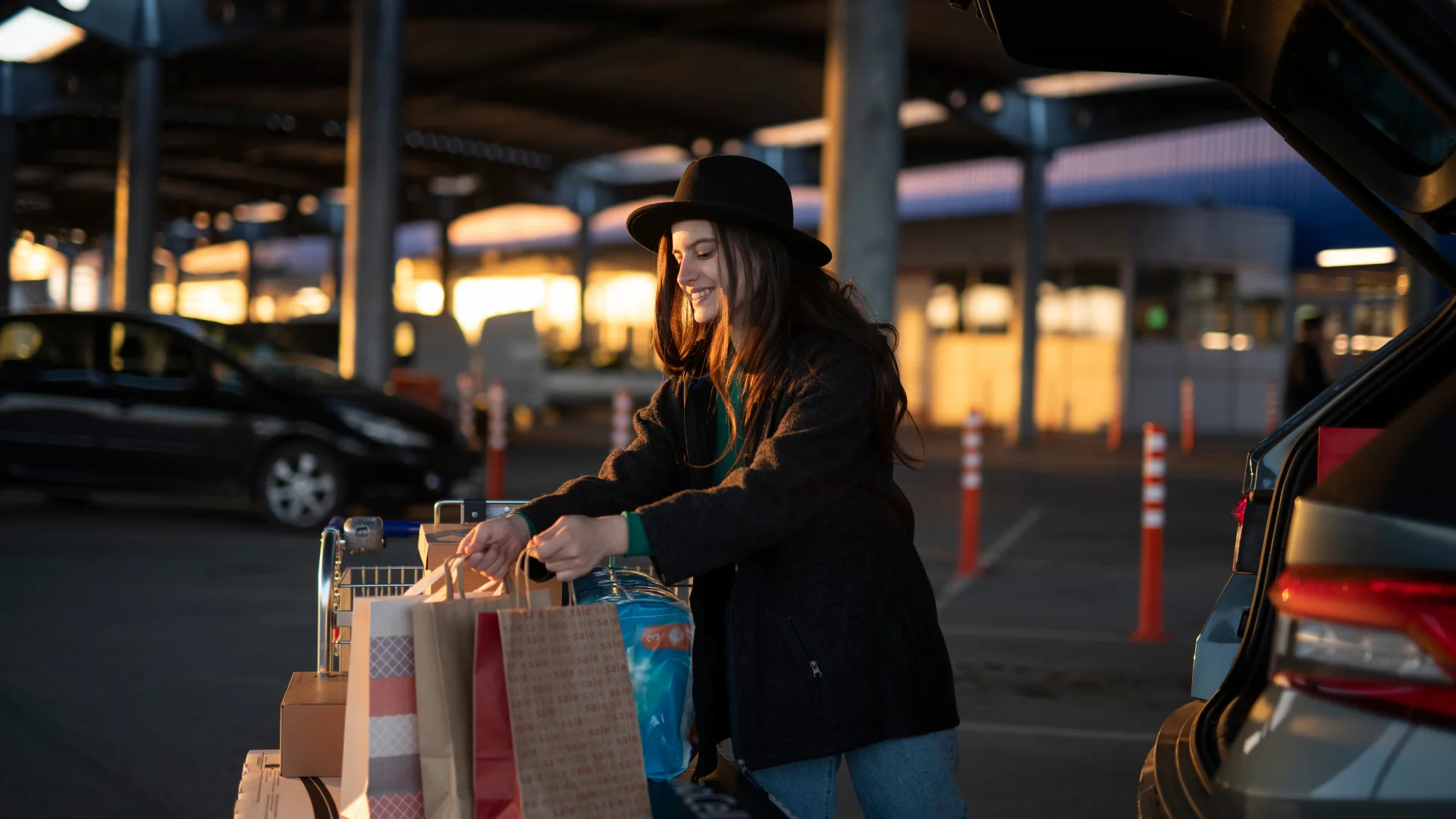 BFCM Logistics woman putting shopping bags into car trunk