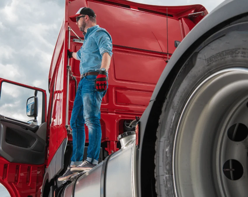 Become a Carrier truck driver with sunglasses on standing on red truck's rig