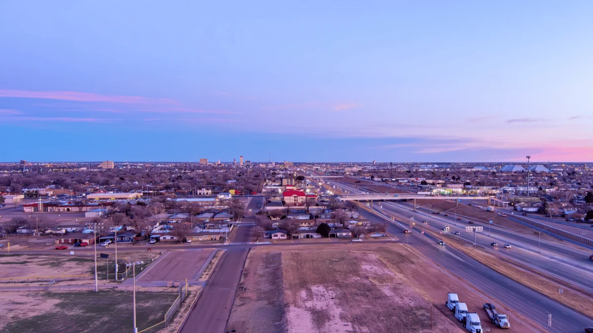 Lubbock Freight Shipping aerial view of Lubbock with buildings in the distance and traffic in the foreground at evening