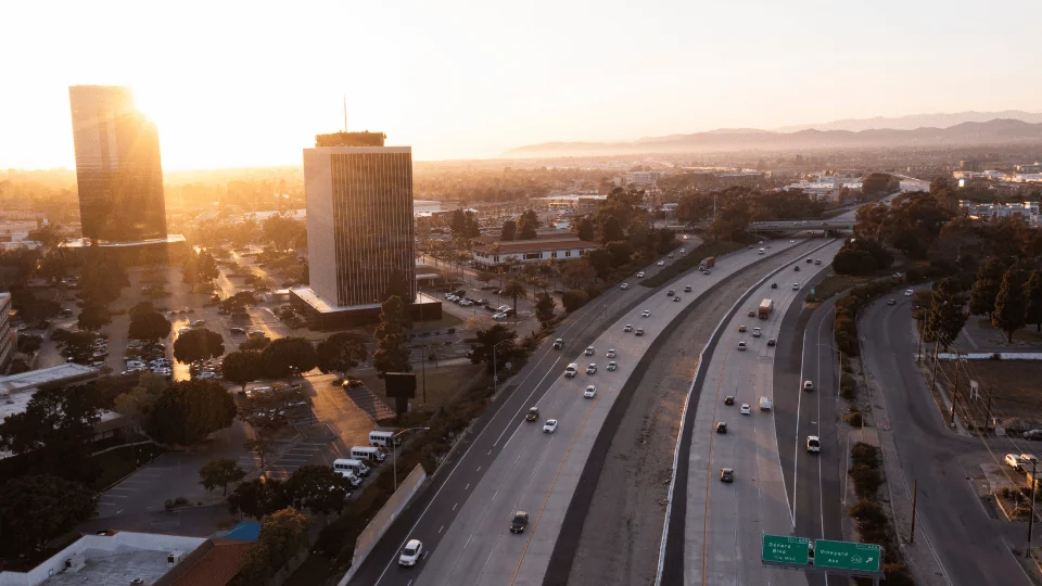 Oxnard Freight Shipping aerial view of highway next to downtown Oxnard at sunset