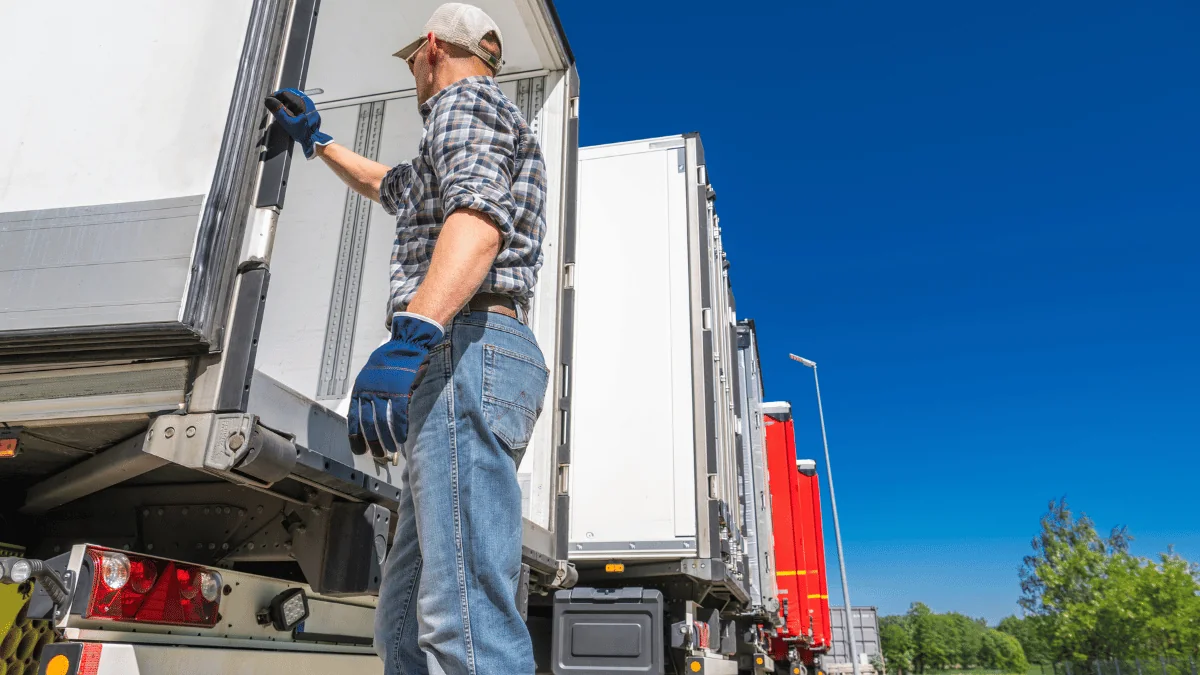 Schedule a Pickup driver checking inside semi trailer on sunny day