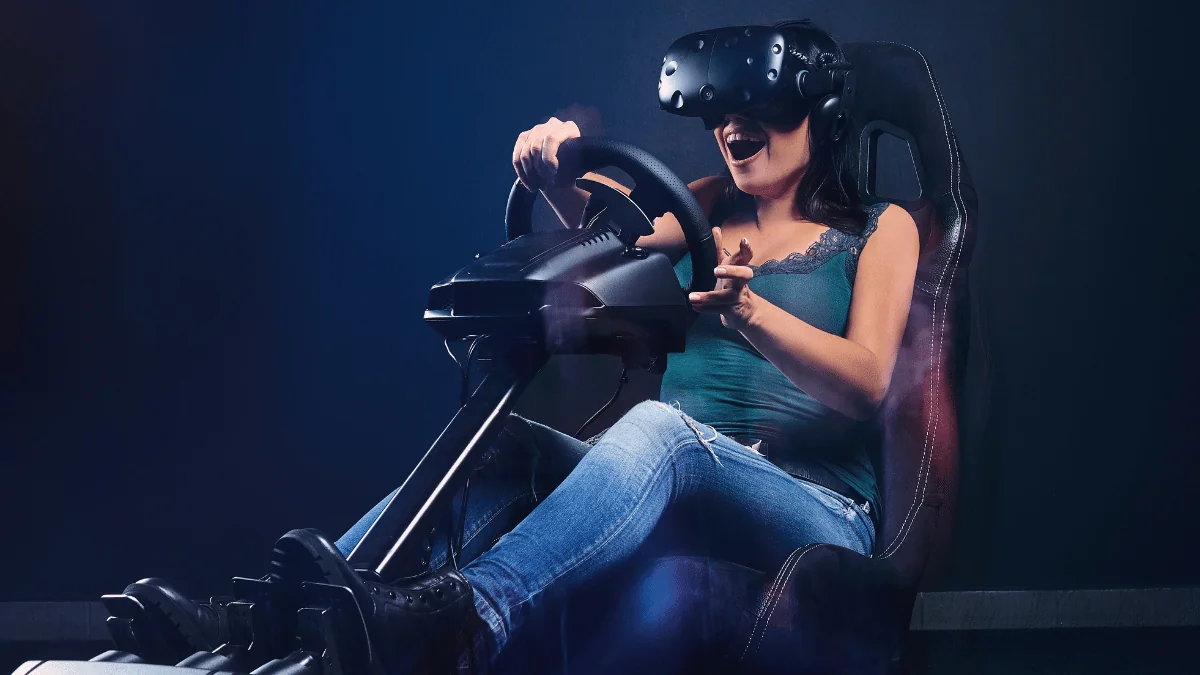 women with VR headset sitting at a driving setup 