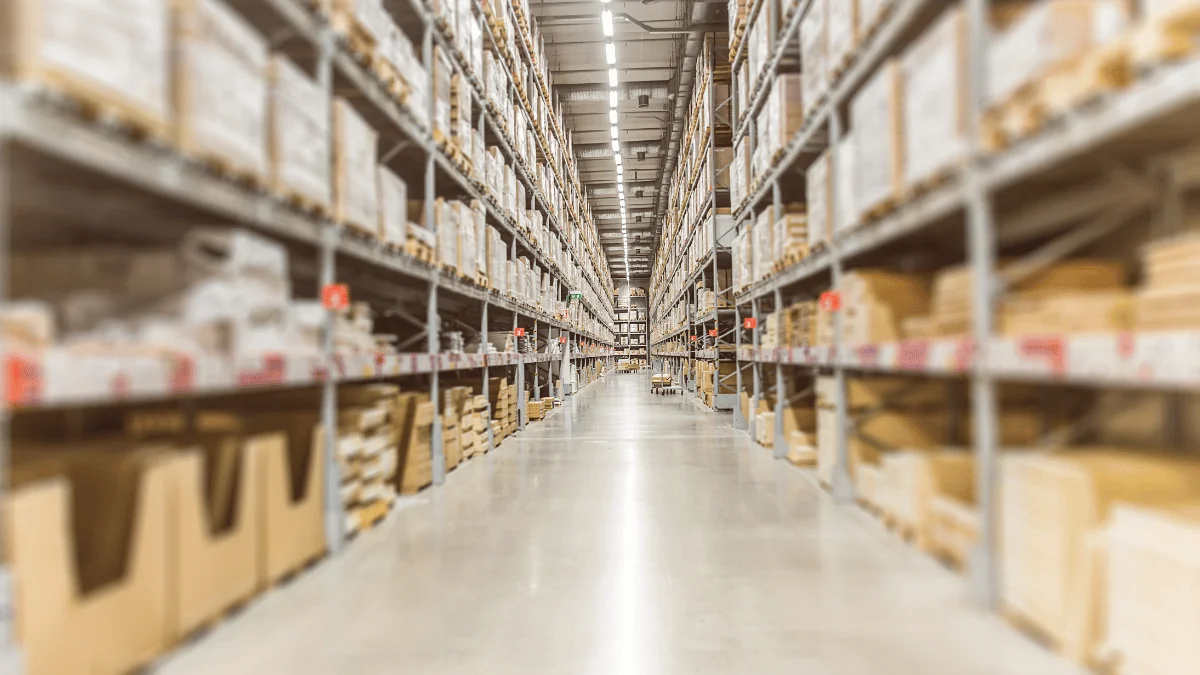 What Is FBA long aisle in warehouse distribution center with boxes and freight lining the shelves