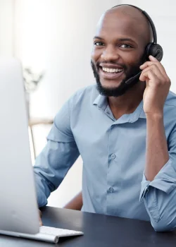 Customer Care Agent talking happily into his headset