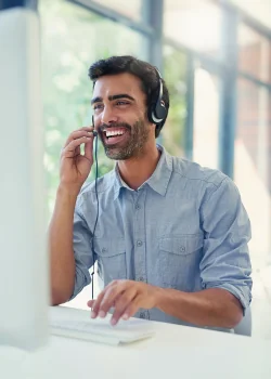 Customer Service Agent chats happily on headset