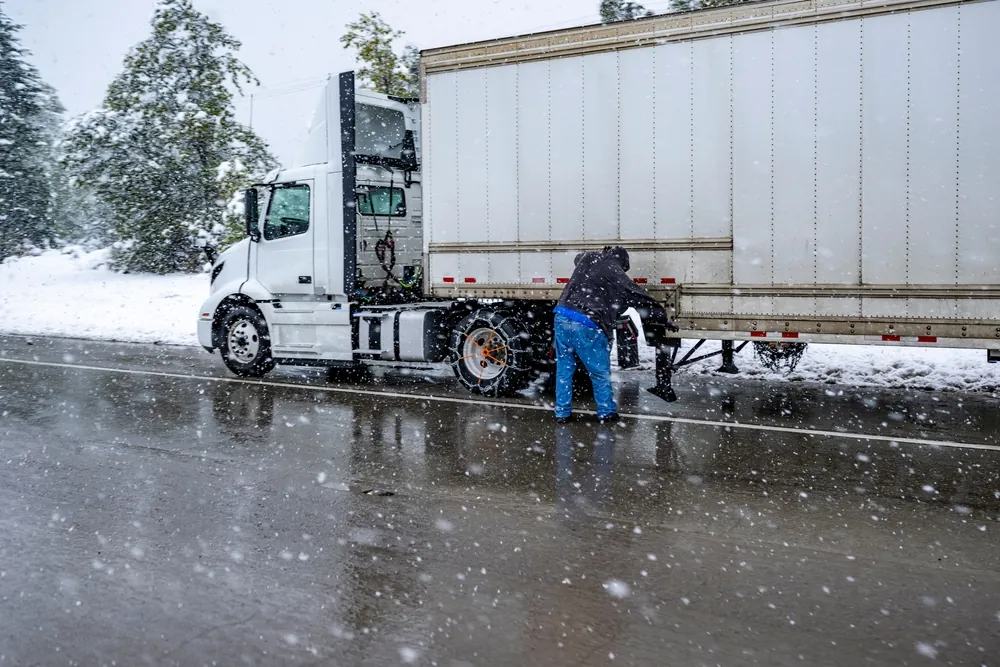 Trucker fixing truck on road