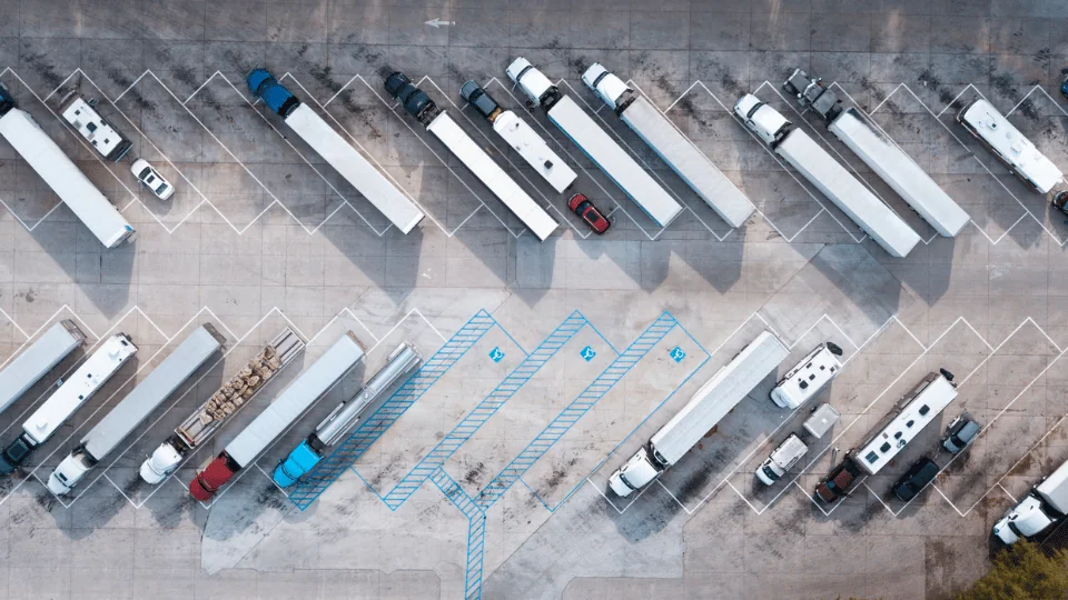 Dedicated Fleet Services rows of trucks parked in semi truck parking lot