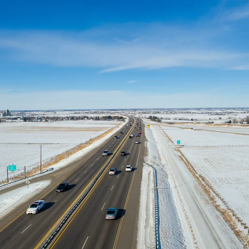 a freeway cutting through a snow-covered field in Minnesota