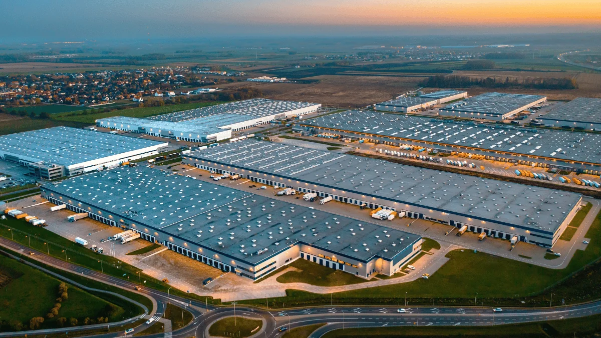 Scalable Supply Chain Solutions aerial view of a logistics center at sunset