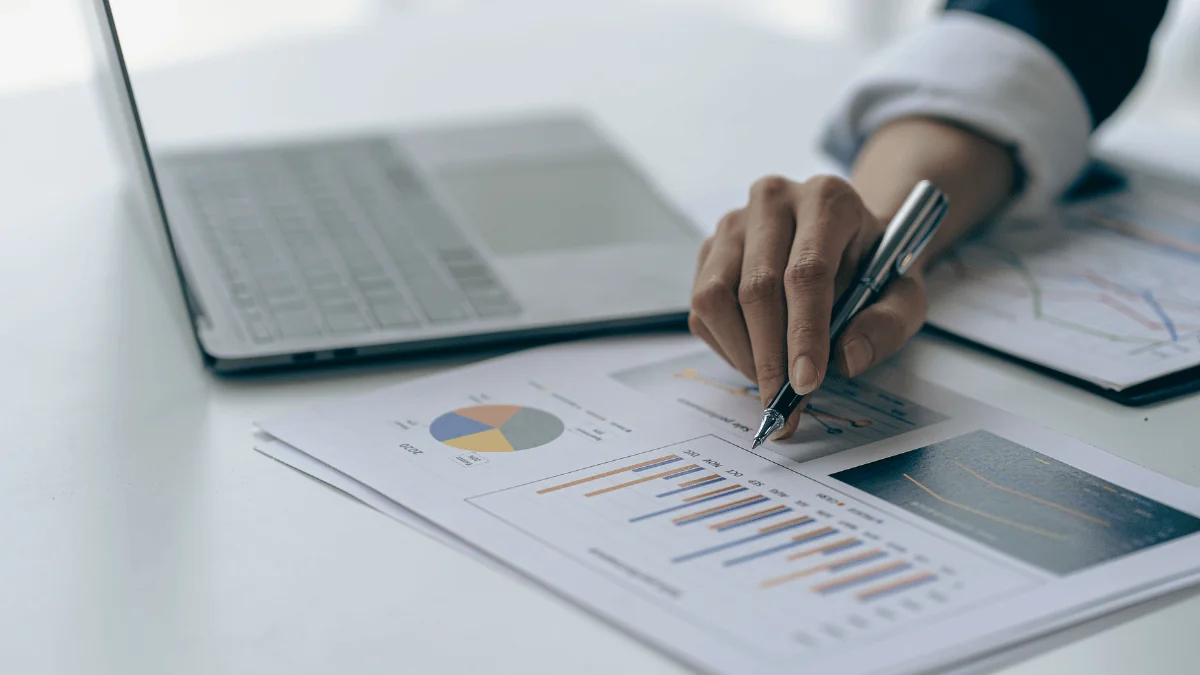 Scalable Supply Chain Solutions business person's hand pointing at graph data with pen