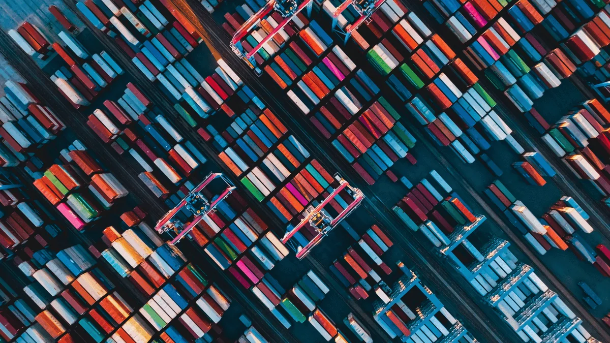 aerial view of shipping containers lined in rows at dock