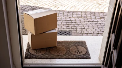 Why is Square Packaging the Default in E-Commerce and Logistics two cardboard box packages on top of welcome mat in front of open door