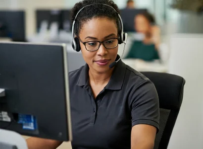 women with headset at computer giving expert customer support