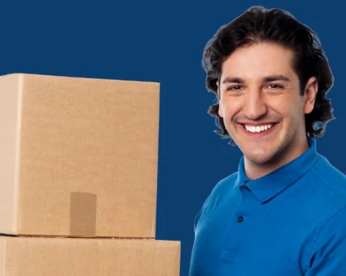 gentlemen in a blue shirt smiling and holding boxes