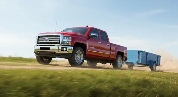 red truck hauling a hot shot trailer